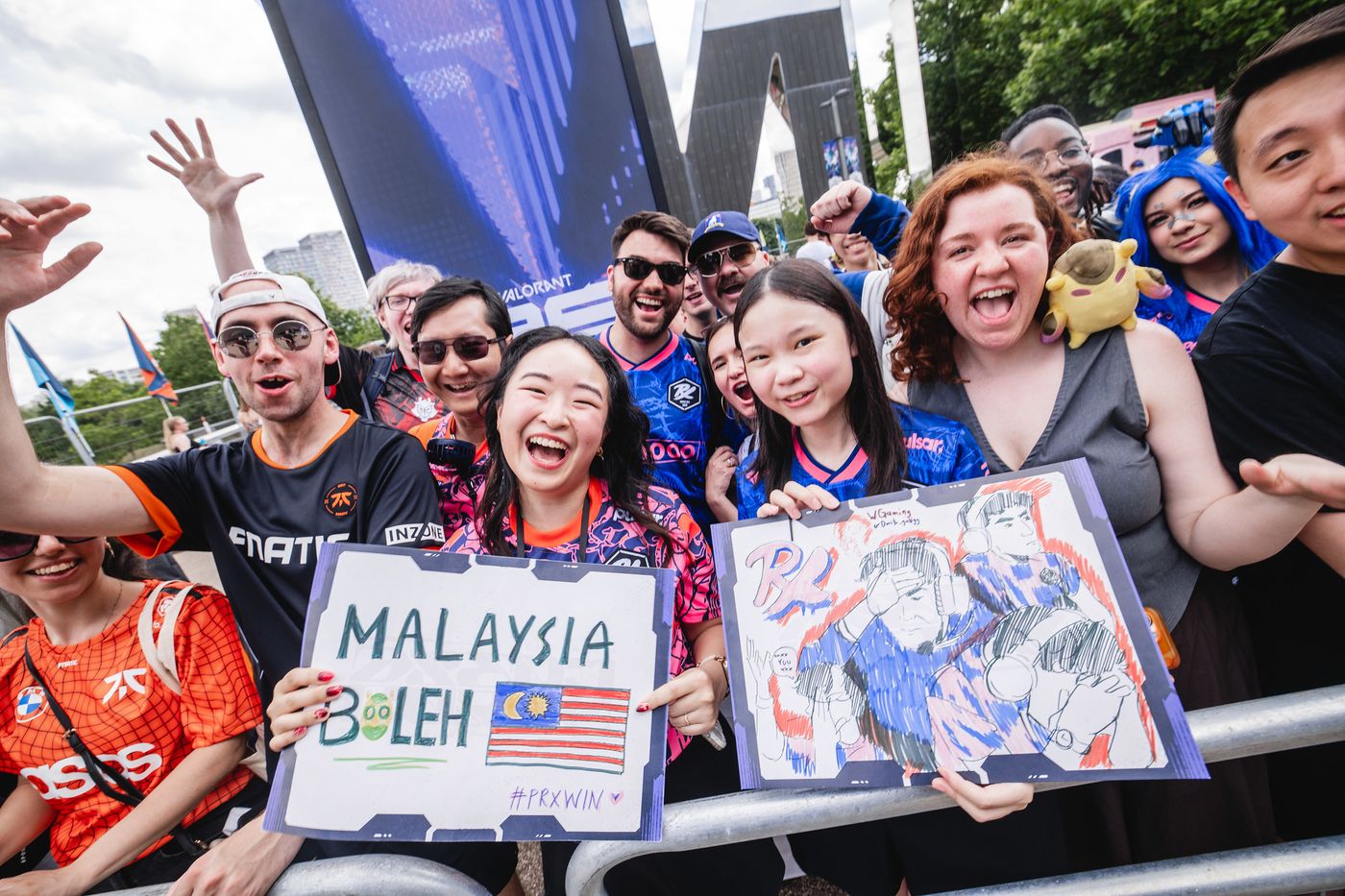 Excited esports fans holding handmade signs at an event